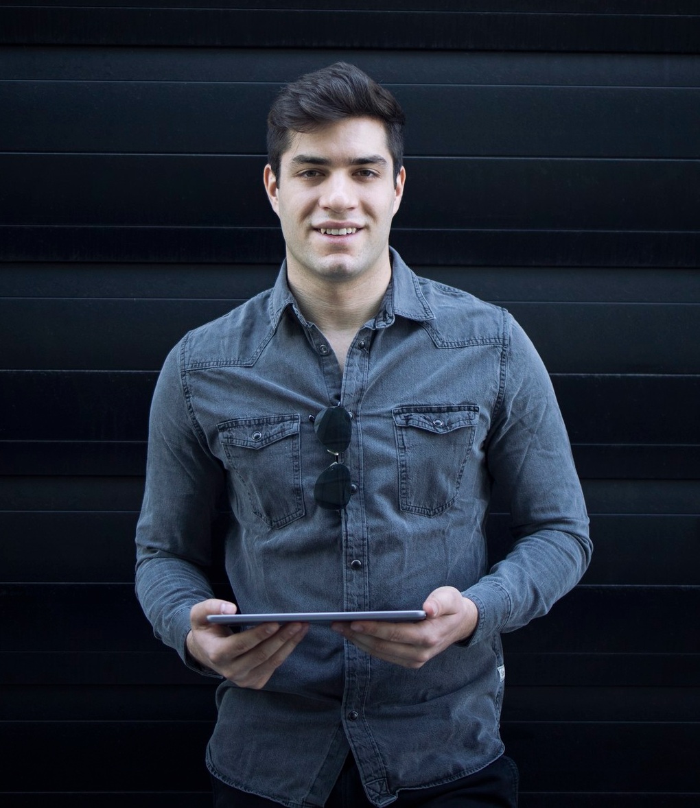 man laughing with tablet in hand